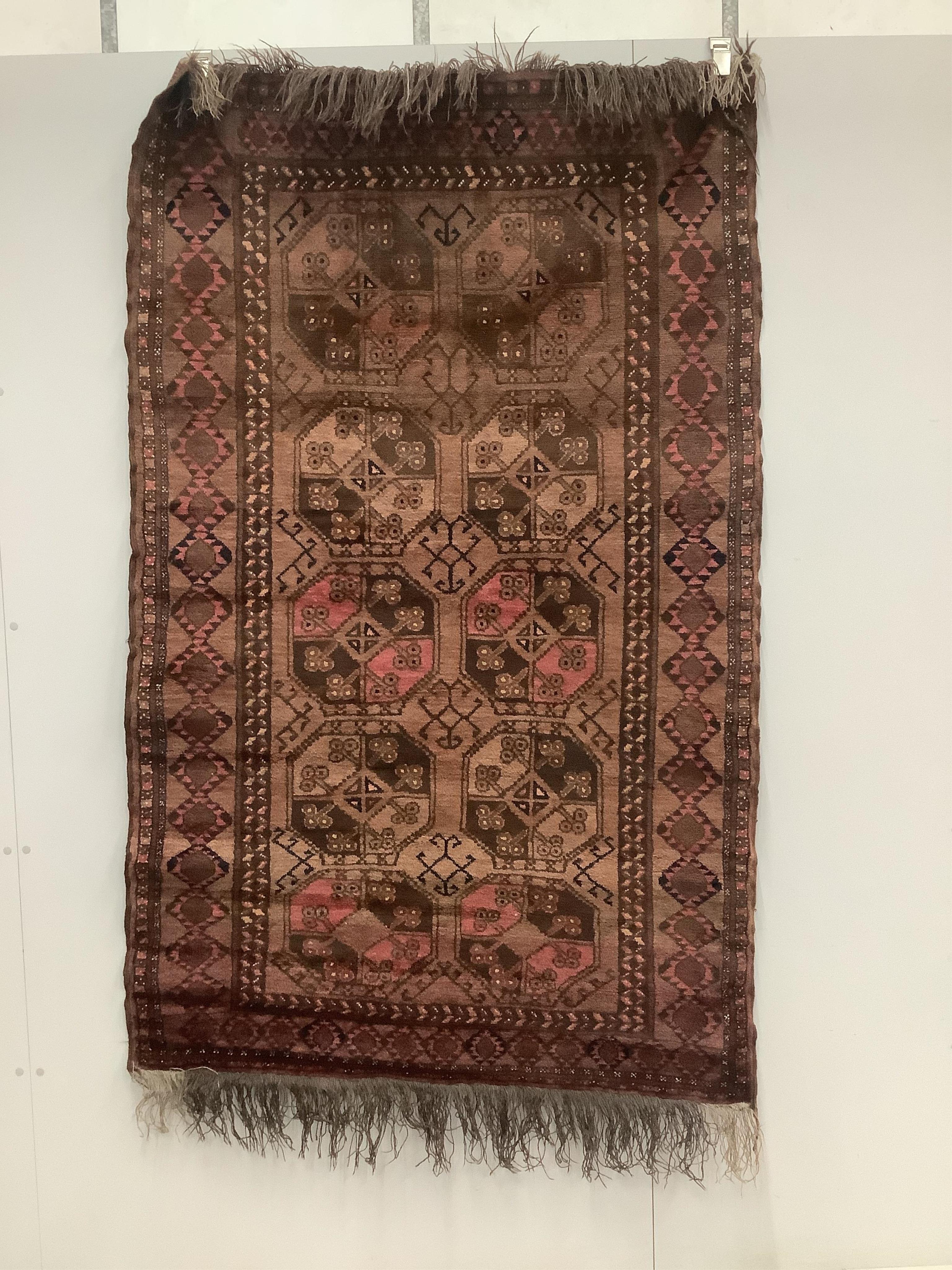 An Afghan red ground rug, 190 x 120cm. Condition - fair